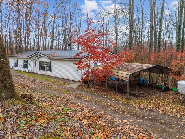 a backyard of a house with table and chairs