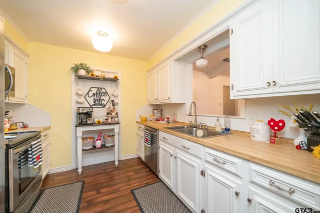 a kitchen with stainless steel appliances a sink stove and cabinets