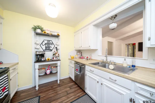 a kitchen with sink refrigerator and cabinets
