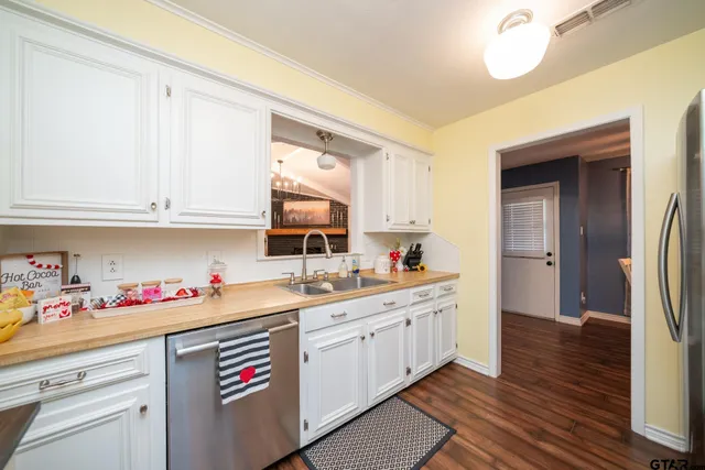 a kitchen with a sink cabinets and wooden floor