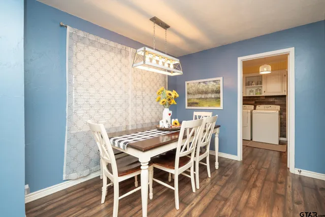 a view of a dining room with furniture and wooden floor