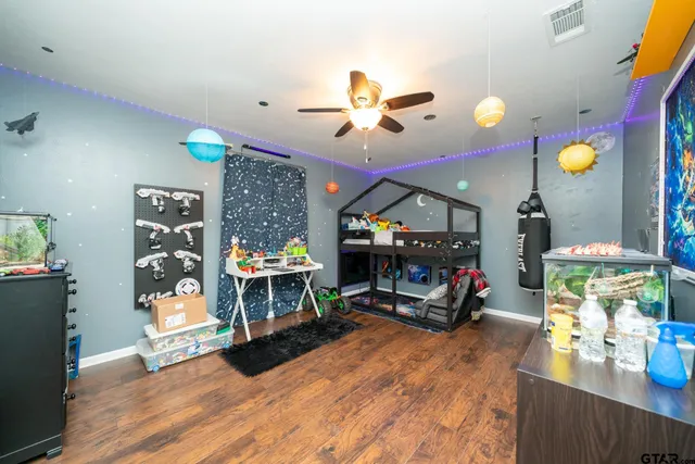 a living room filled with furniture and a wooden floor