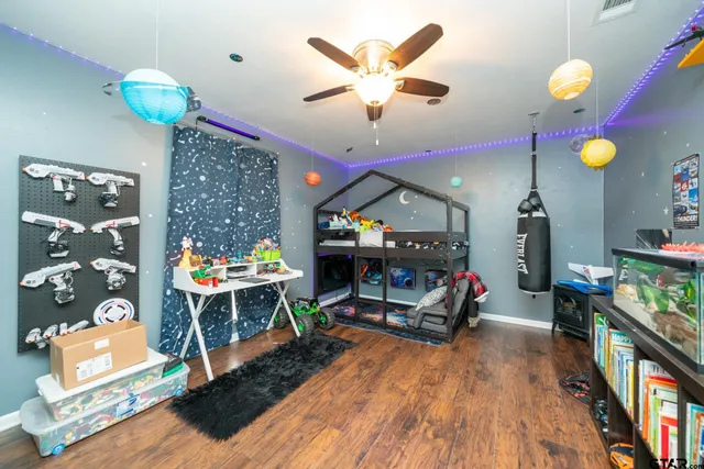 a living room filled with furniture and a wooden floor