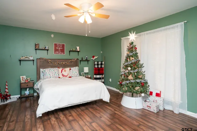 a bedroom with a large bed and a chandelier