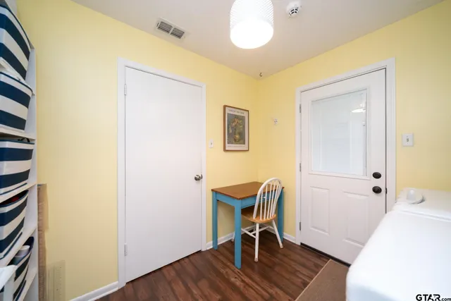 a view of a workspace with furniture and wooden floor