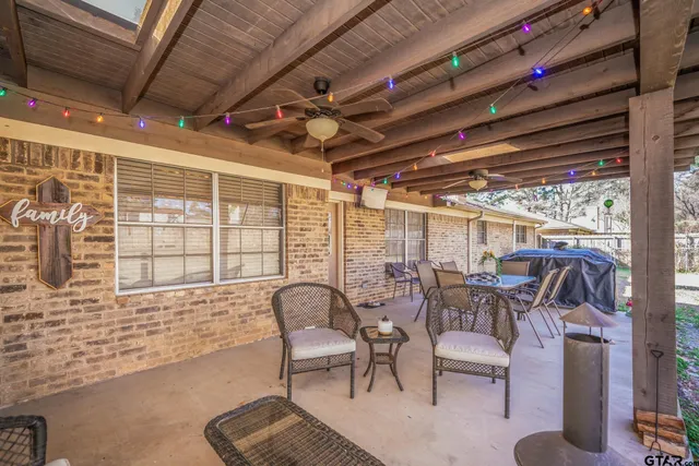 a dining room with furniture and a floor to ceiling window
