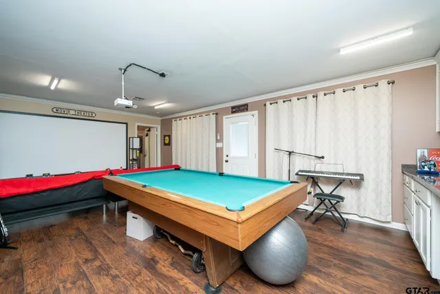 a room with pool table and windows
