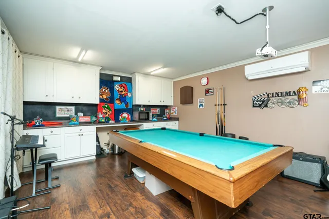 a living room with kitchen island furniture and a flat screen tv