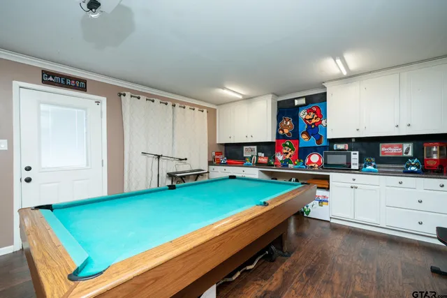a kitchen with green walls cabinets and appliances