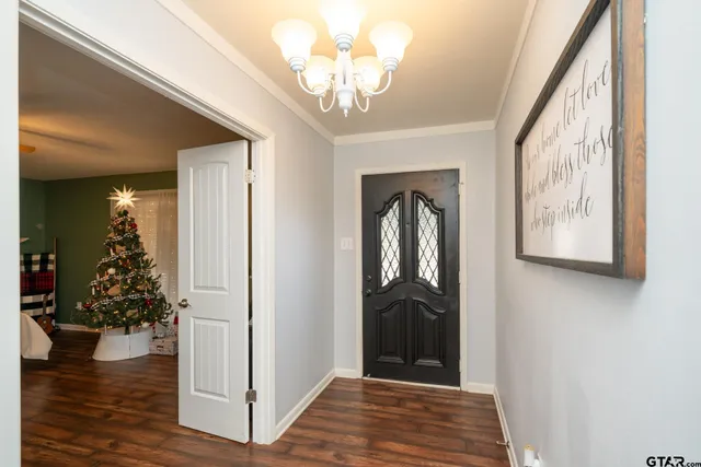 a view of a hallway to a livingroom with furniture