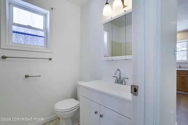 a bathroom with a toilet sink and mirror