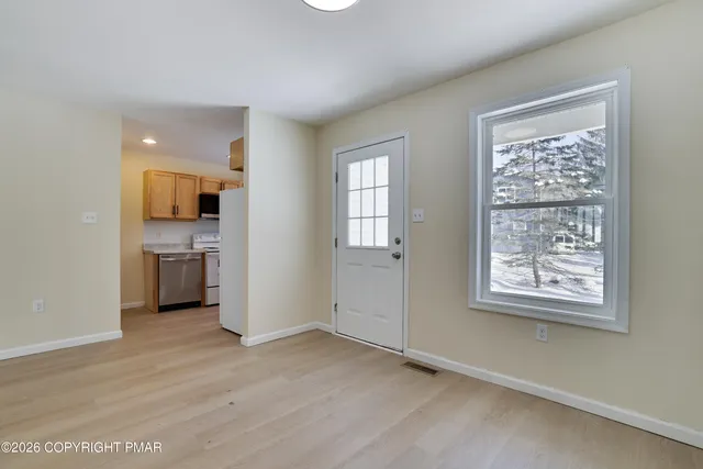 a view of a kitchen with a sink and a window