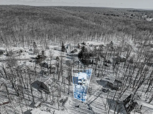 a view of a white house with tree s