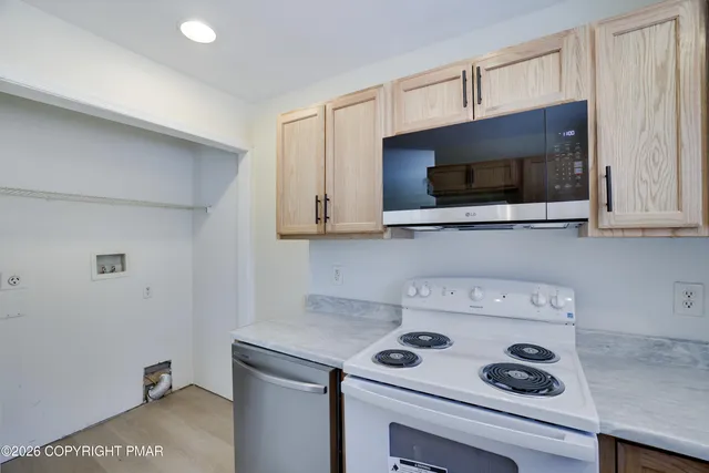 a kitchen with a stove and a microwave