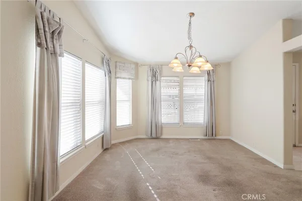 a kitchen with a stove window and cabinets