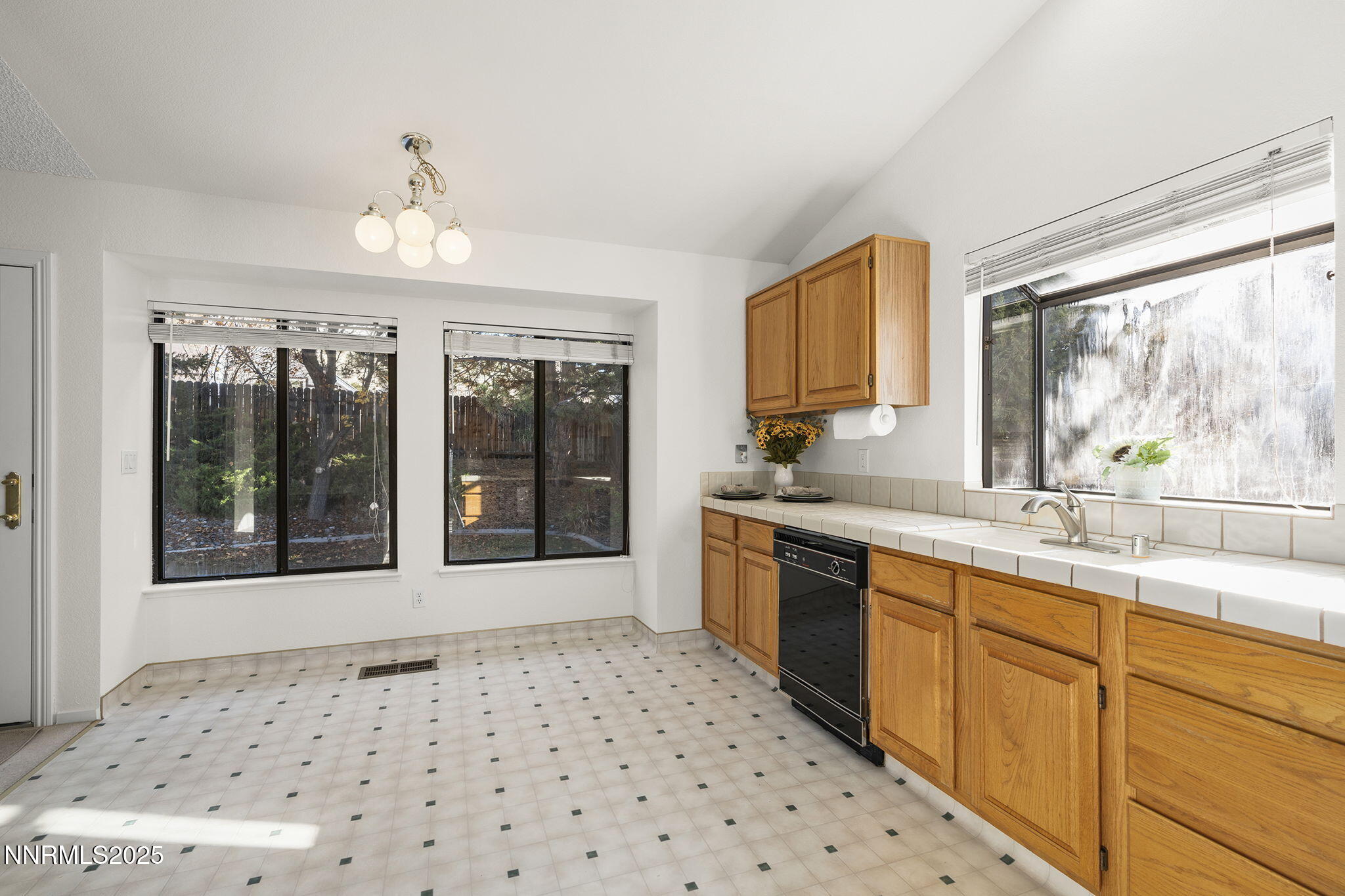 5466 Santa Rosa Avenue Sparks, NV 89436 - Photo 23 of 36 a large white kitchen with granite countertop a sink window and cabinets