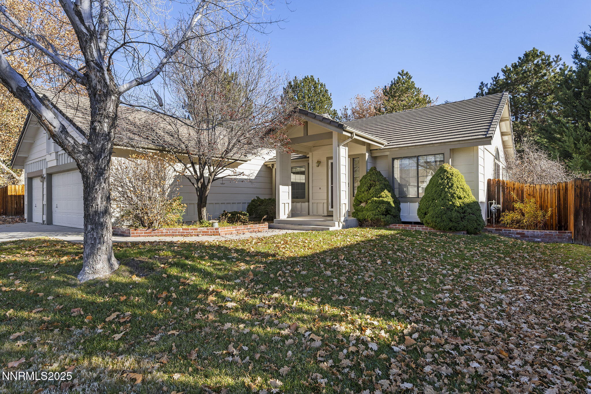 5466 Santa Rosa Avenue Sparks, NV 89436 - Photo 28 of 36 a view of a white house with a yard and large tree