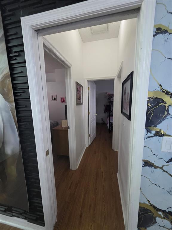 17820 Monteverde Drive Spring Hill, FL 34610 - Photo 21 of 42 a view of a hallway with wooden floor and livingroom with furniture