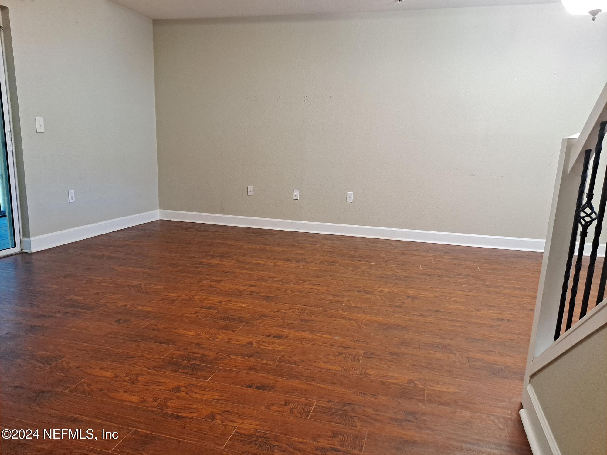9745 Touchton Road, Unit 927 Jacksonville, FL 32246 - Photo 11 of 22 a view of an empty room with wooden floor and a window