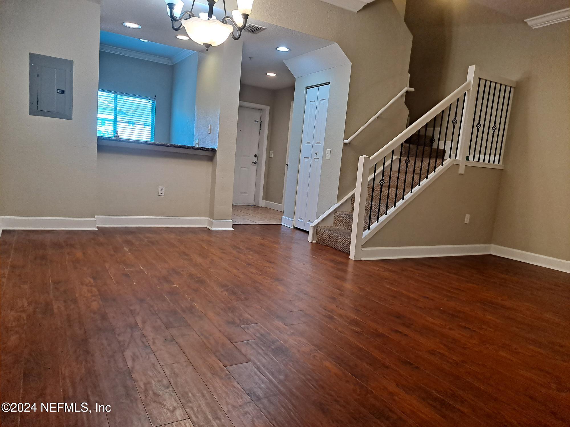 9745 Touchton Road, Unit 927 Jacksonville, FL 32246 - Photo 12 of 22 wooden floor in an empty room with a mirror