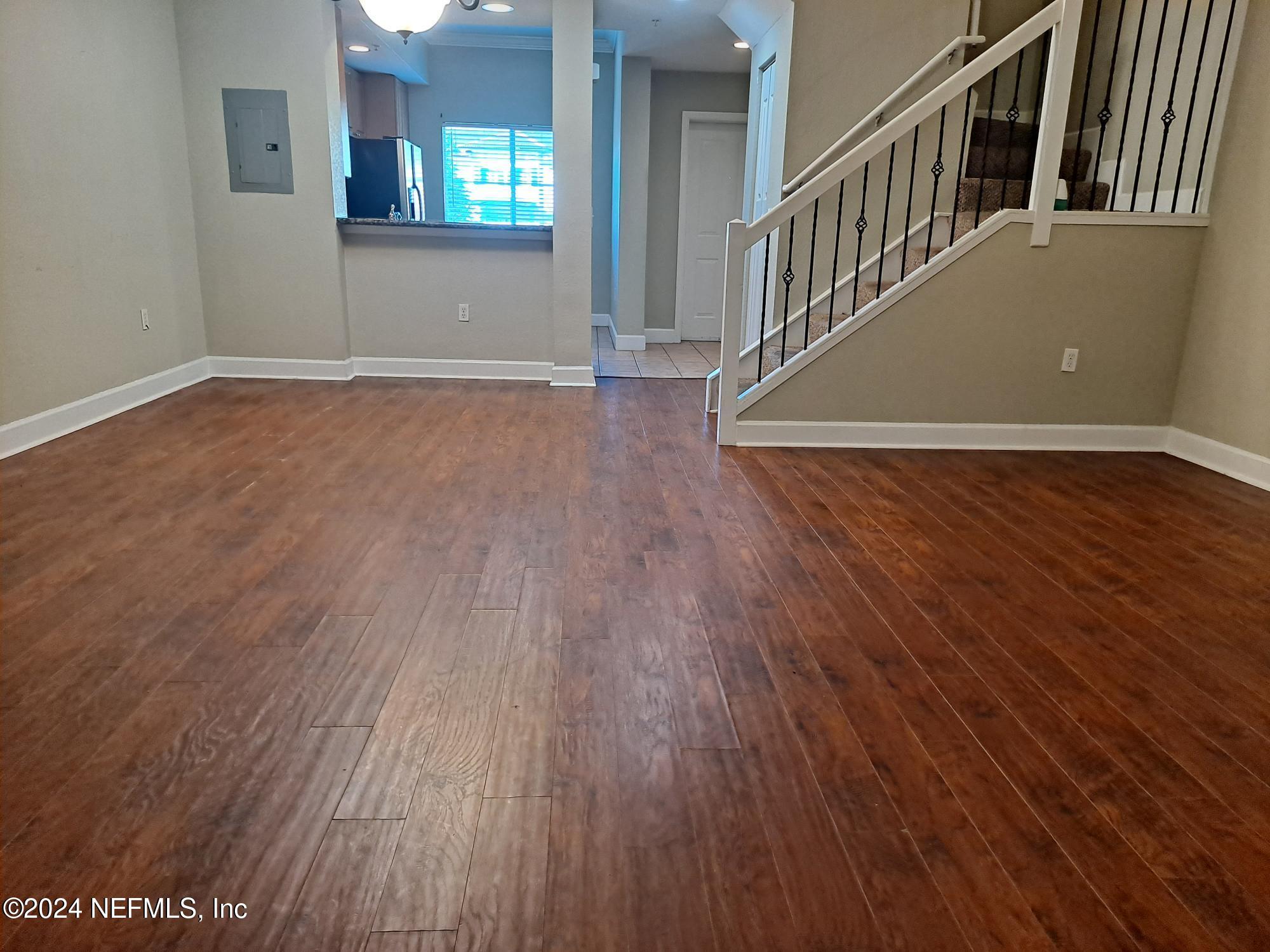 9745 Touchton Road, Unit 927 Jacksonville, FL 32246 - Photo 13 of 22 wooden floor in an empty room with windows