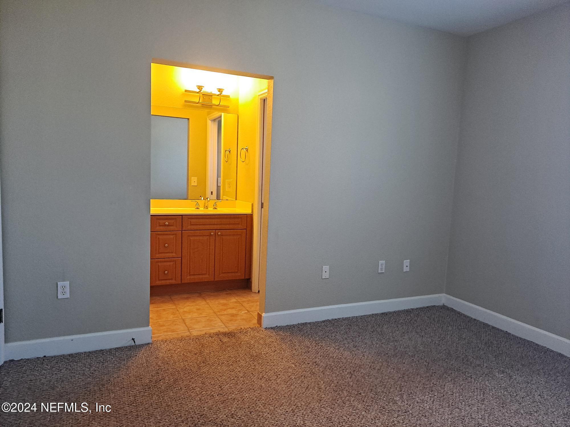 9745 Touchton Road, Unit 927 Jacksonville, FL 32246 - Photo 16 of 22 an empty room with a window and a mirror