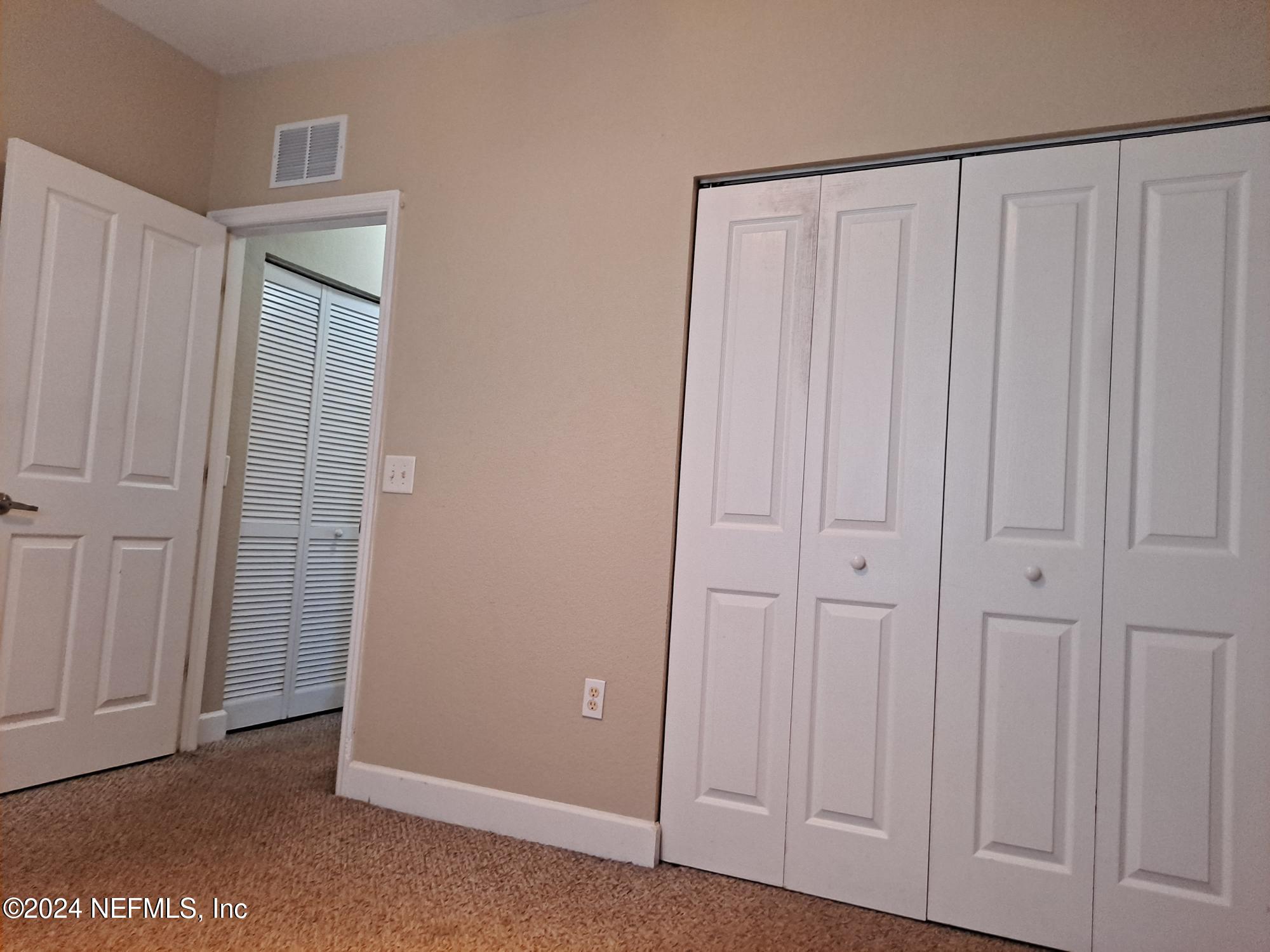 9745 Touchton Road, Unit 927 Jacksonville, FL 32246 - Photo 20 of 22 an empty room with a wooden door