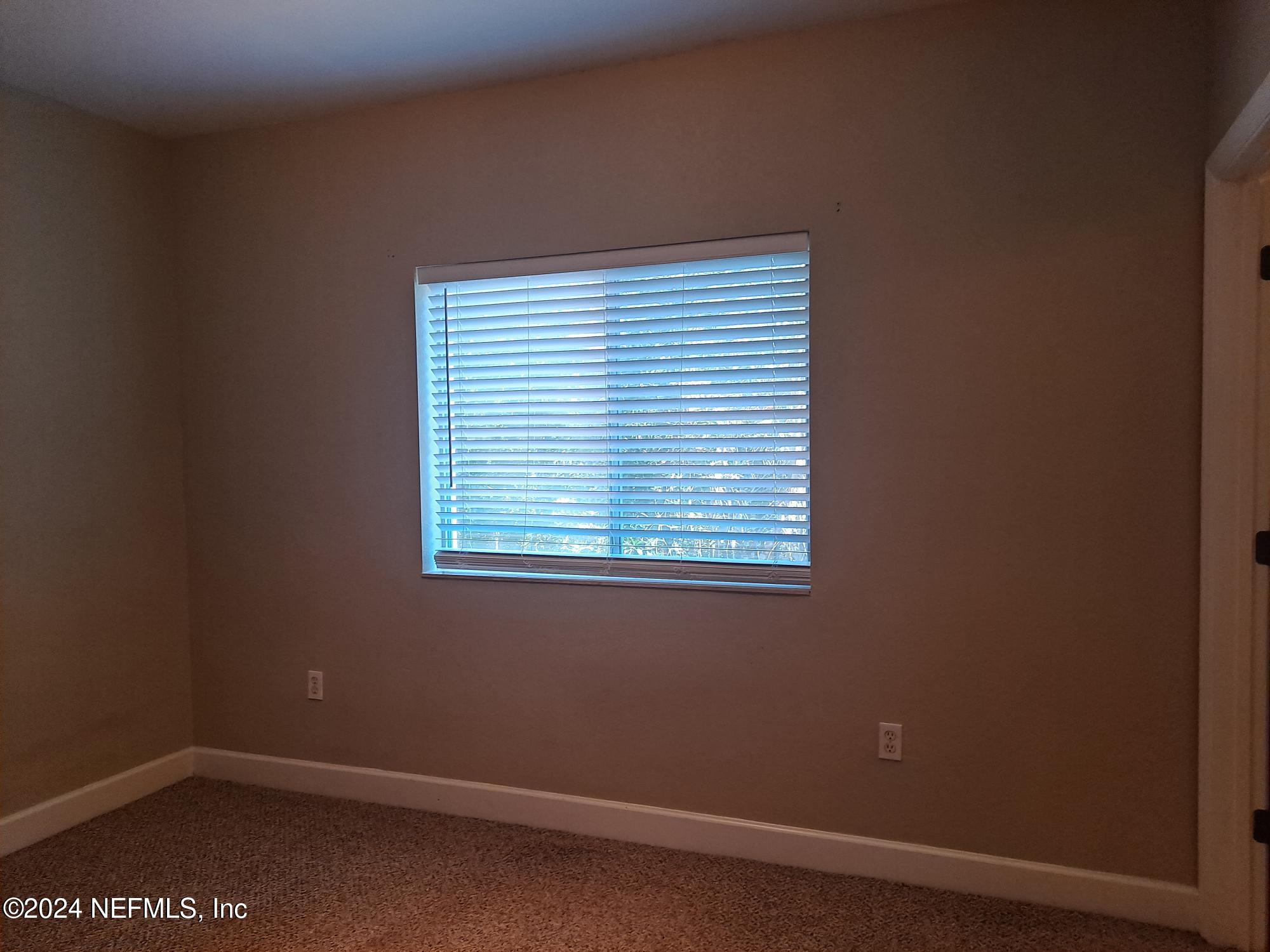 9745 Touchton Road, Unit 927 Jacksonville, FL 32246 - Photo 22 of 22 an empty room with a window