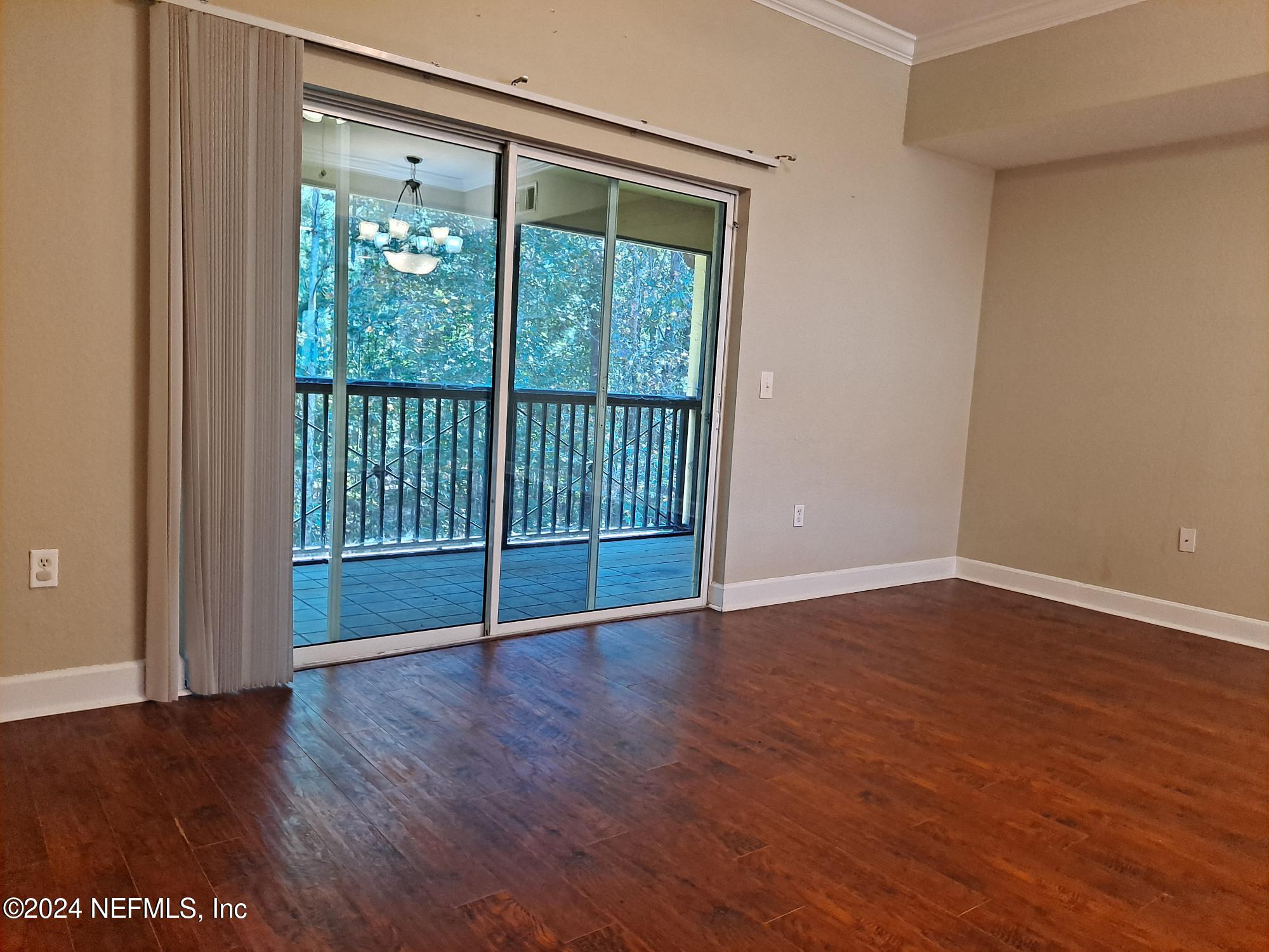 9745 Touchton Road, Unit 927 Jacksonville, FL 32246 - Photo 8 of 22 a view of an empty room with wooden floor and a window