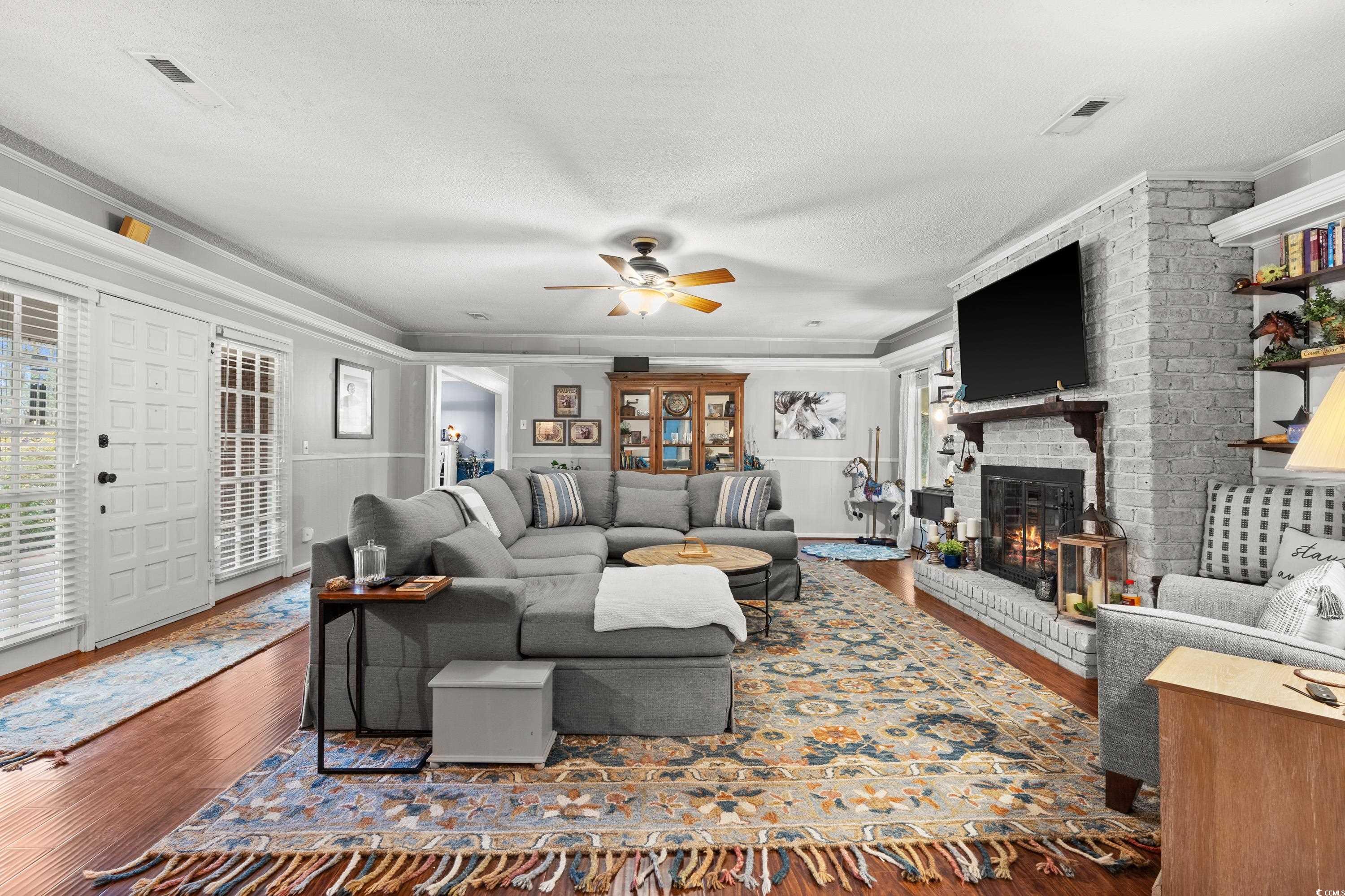 3696 Sandy Bay Road Kingstree, SC 29556 - Photo 8 of 40 Living room featuring ornamental molding, dark har