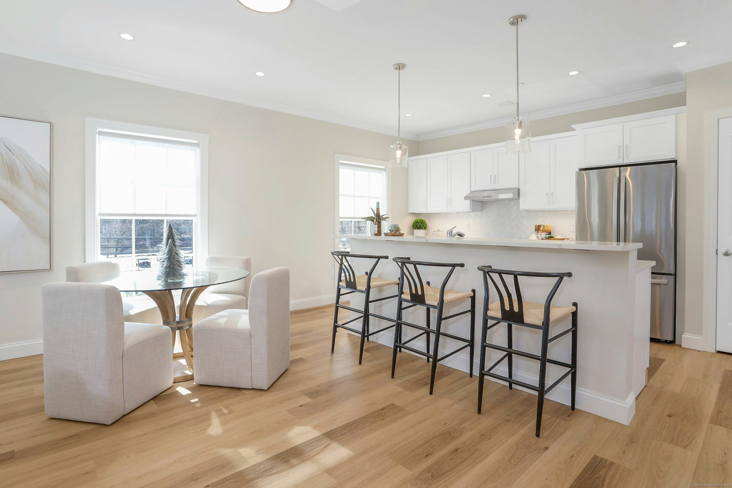 340 Heights Road, Unit 322 Darien, CT 06820 - Photo 3 of 15 a kitchen with stainless steel appliances granite countertop a stove a sink a refrigerator and white cabinets with wooden floor