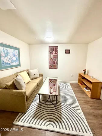 a living room with furniture and a rug