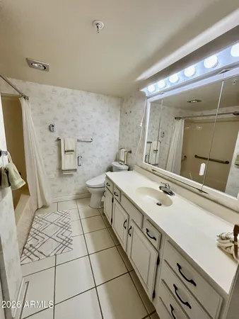 a spacious bathroom with a sink a mirror and a shower