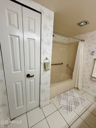 a bathroom with a glass door shower and a mirror