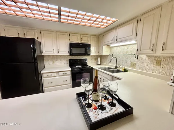 a kitchen with a refrigerator a stove a sink and a cabinets