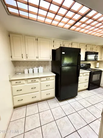 a kitchen with stainless steel appliances granite countertop a refrigerator and a stove