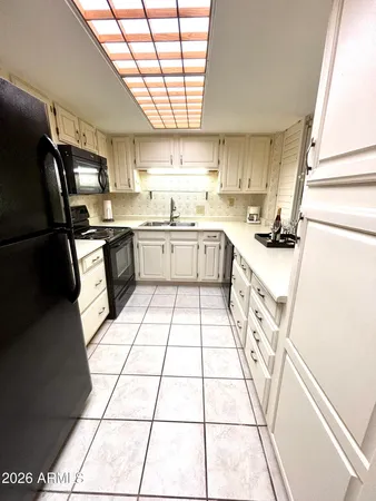a kitchen with stainless steel appliances granite countertop a stove a sink dishwasher and a refrigerator