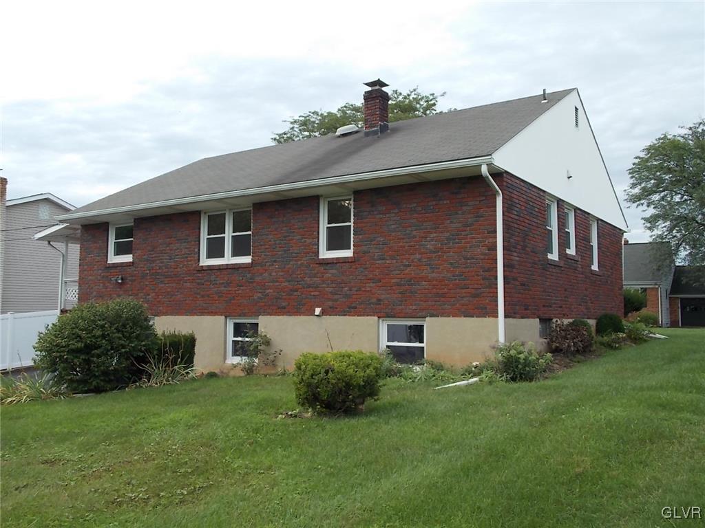 4244 Briarcliff Road Allentown, PA 18104 - Photo 4 of 13 a brick house with a yard