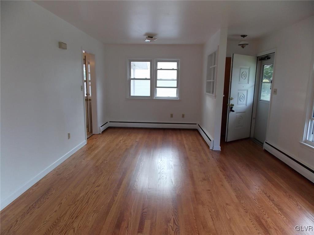 4244 Briarcliff Road Allentown, PA 18104 - Photo 7 of 13 an empty room with wooden floor and windows
