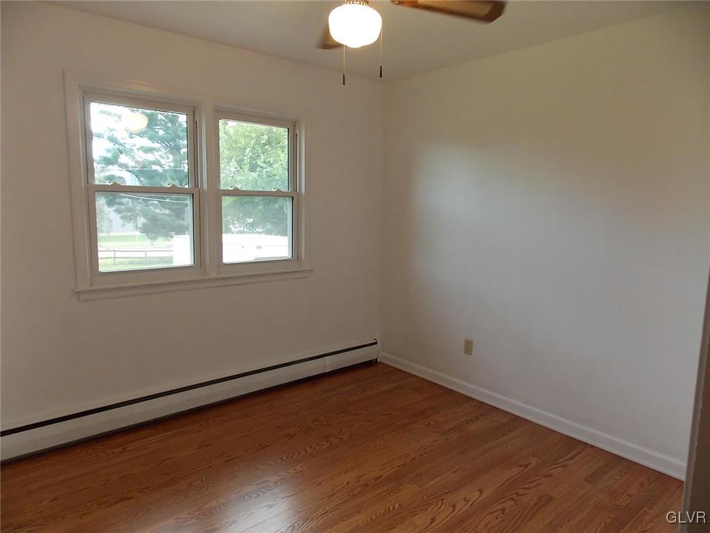4244 Briarcliff Road Allentown, PA 18104 - Photo 10 of 13 an empty room with wooden floor and windows