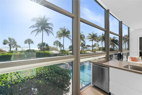 a kitchen with stainless steel appliances kitchen island granite countertop a refrigerator and a stove top oven