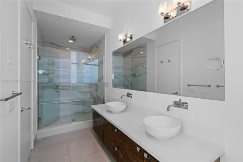 a bathroom with a glass shower door