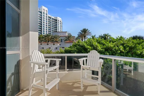 a view of a chairs and table in patio with a swimming pool