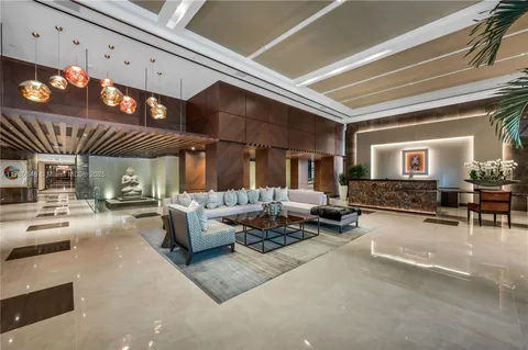 a living room with fireplace furniture and a large window