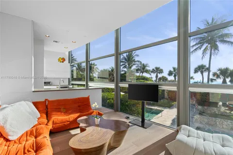 a living room with furniture and large window