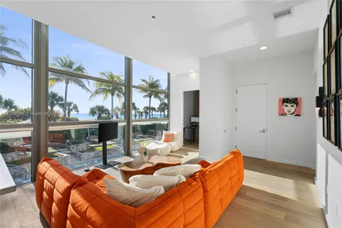 a bedroom with a bed and a large window with outer view