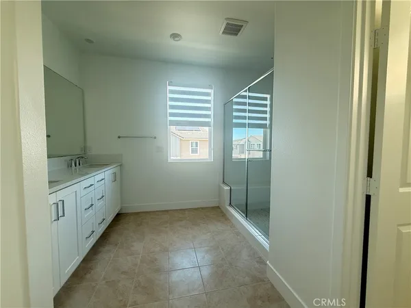 a bathroom with 2 sink tub and a mirror