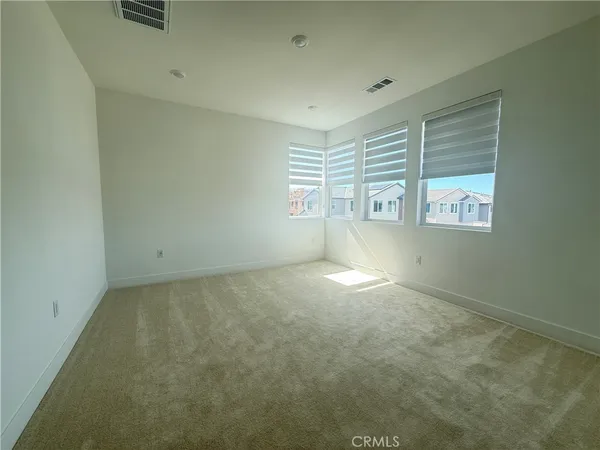 a view of an empty room and closet area