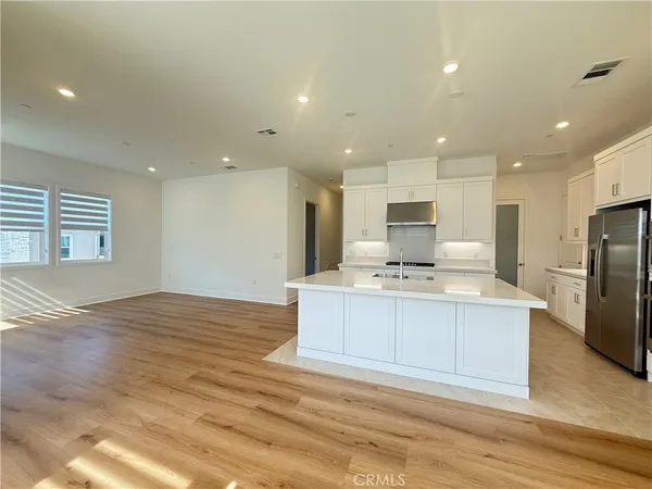 a stove top oven sitting inside of a kitchen