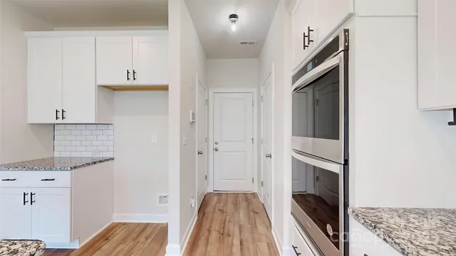 a view of hallway with wooden floor